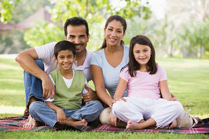 A family sitting outside together. Links to Beneficiary Designations